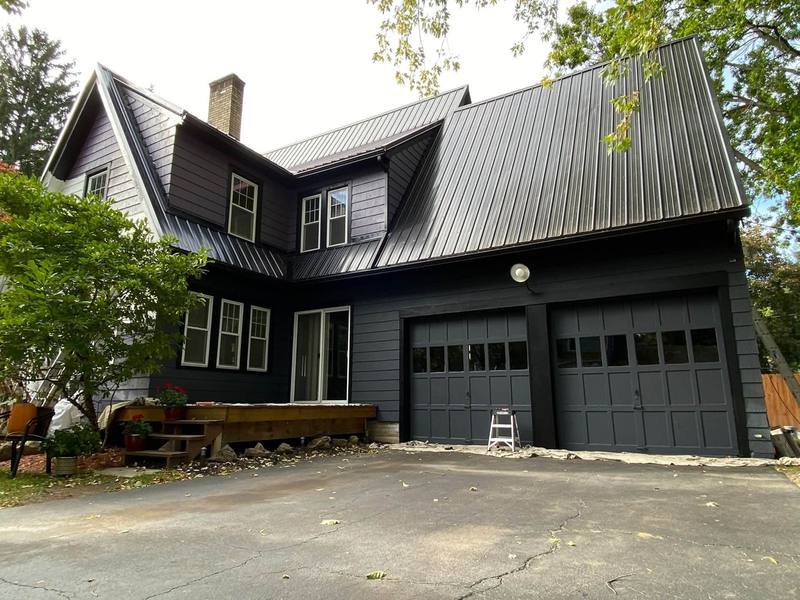 Dark painted house with black metal roof