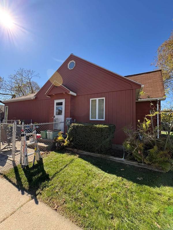 Red house exterior seen from the side yard