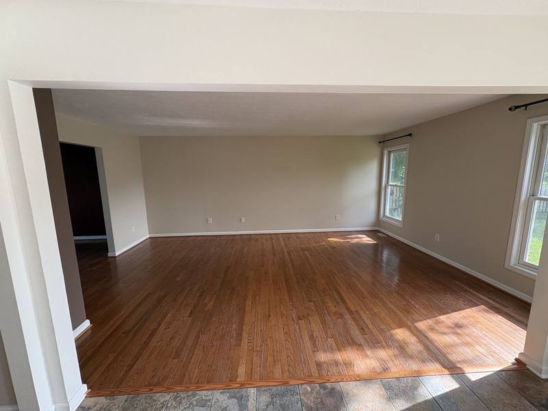 Empty room with hardwood floors and freshly painted white walls